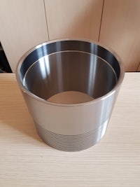 a stainless steel bowl sitting on a wooden table