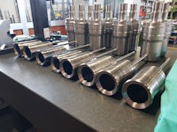 a group of stainless steel pipes on a table